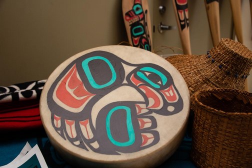 Drum, hats and paddles depicting Southeast Alaskan Native American culture.