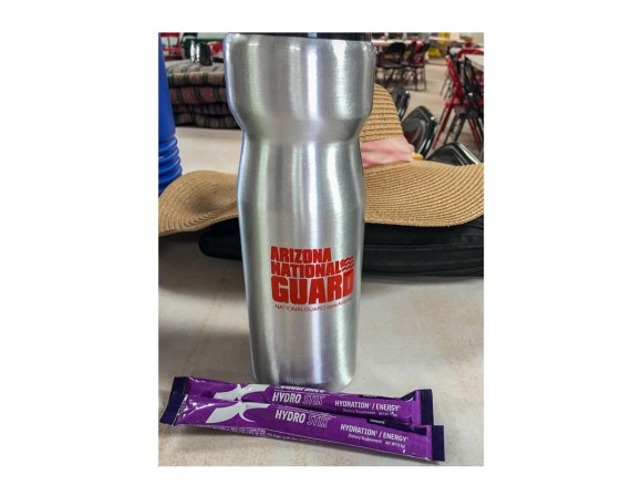 Silver water bottle labeled "Arizona National Guard" with two packets of Xendurance Hydro Stix displayed in foreground.