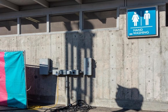 Bank of electrical outlets for wheelchair recharging, located outside a hand-washing station at the California State Fair.