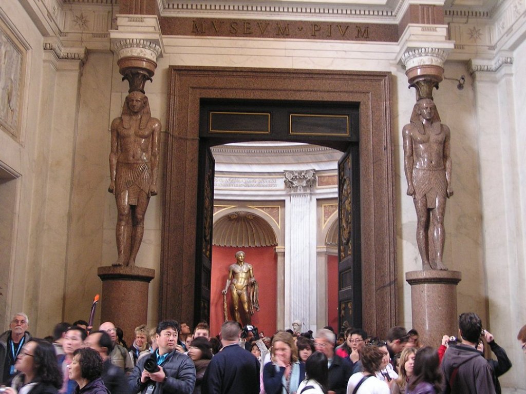 Crowded hallway in Egyptian section of Vatican Museum.