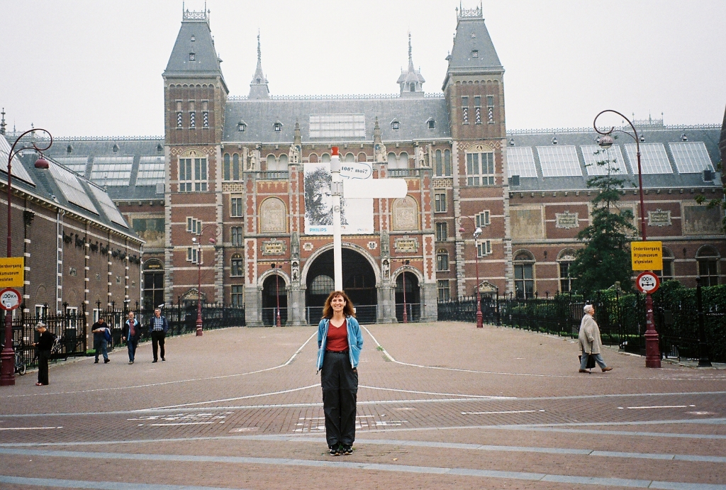Woman standing in front of Rijksmuseum in Amsterdam.